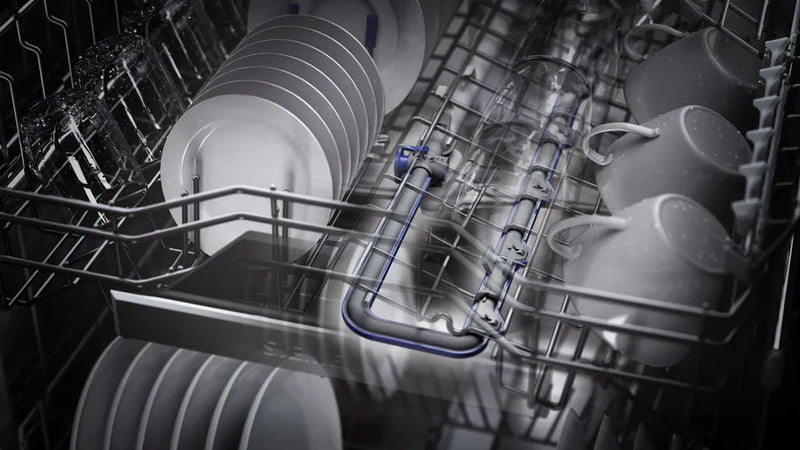 Dishwasher with racks filled with clean dishes in a black and white filter.