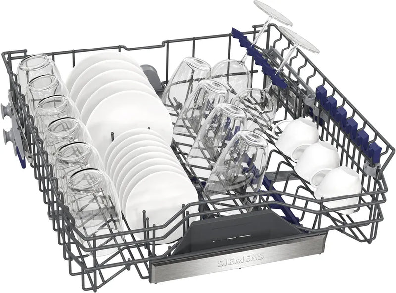 Dishwasher rack with cutlery and plates on a white background